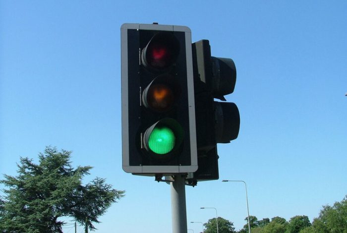 When approaching a steady green traffic light drivers should